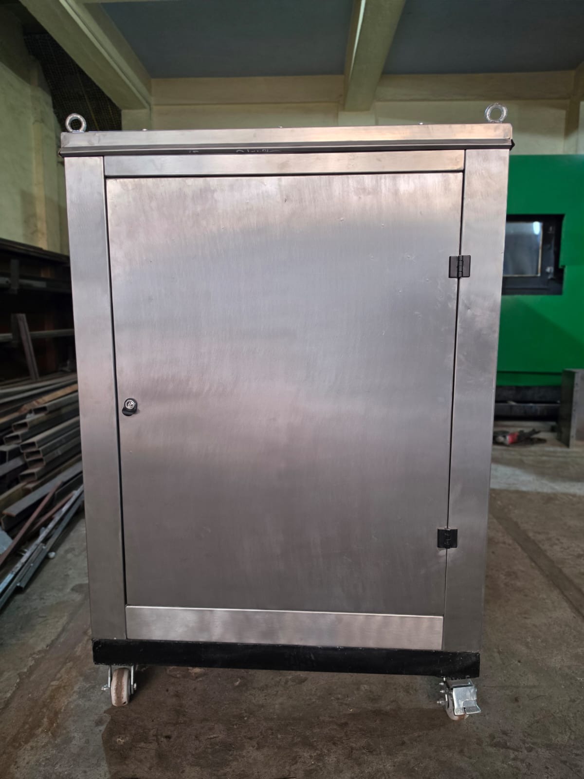 Side view of the SS304 composter showing lockable door, lifting eye bolts, and heavy-duty braking castors
