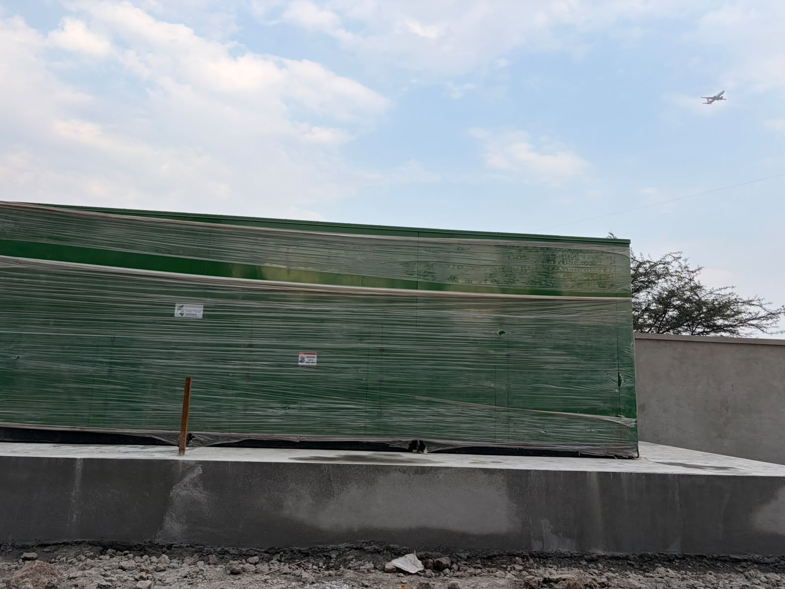 Side view showing output port of composting machine at Rohan Yuva