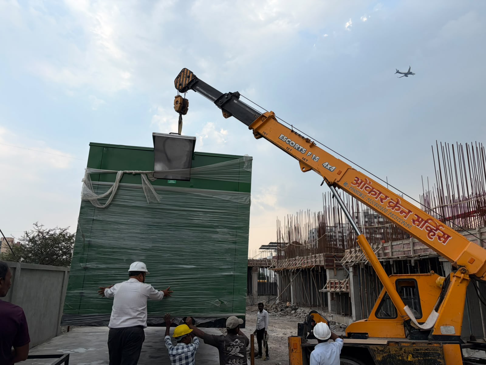 Crane-lifting composting machine into position at Rohan Yuva, Wagholi, Pune